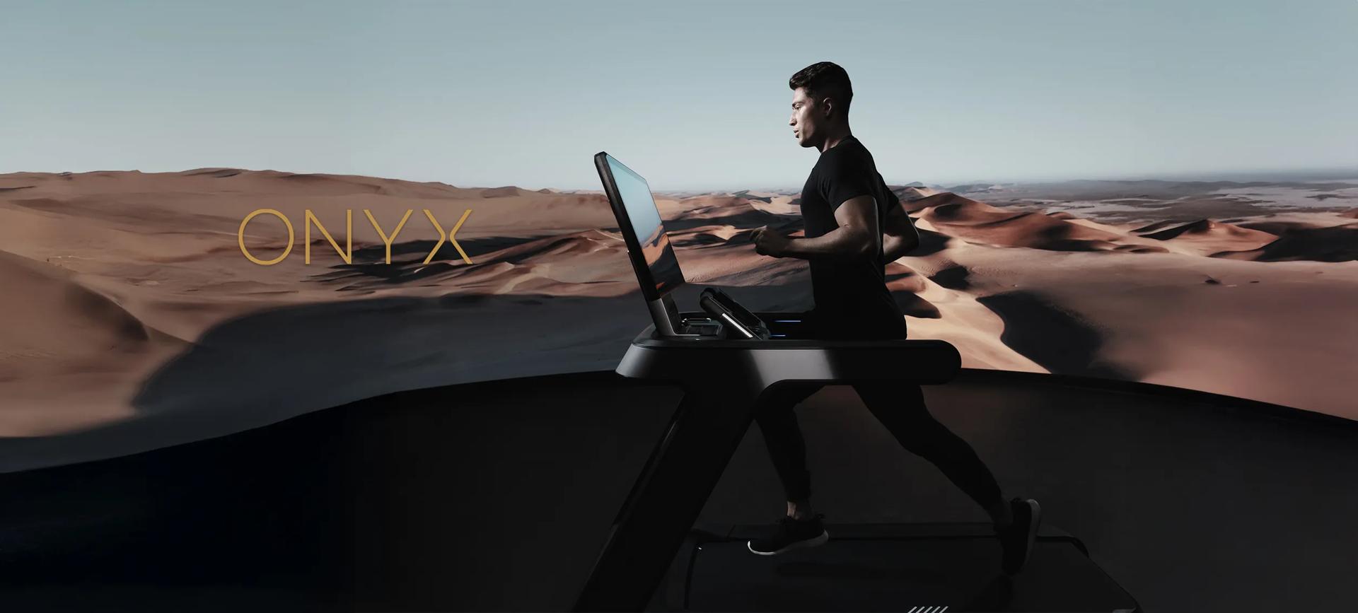Runner on treadmill in front of desert sand hills